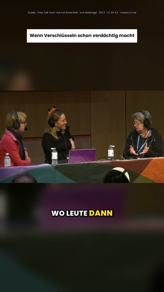 Panel of three speakers with German captions